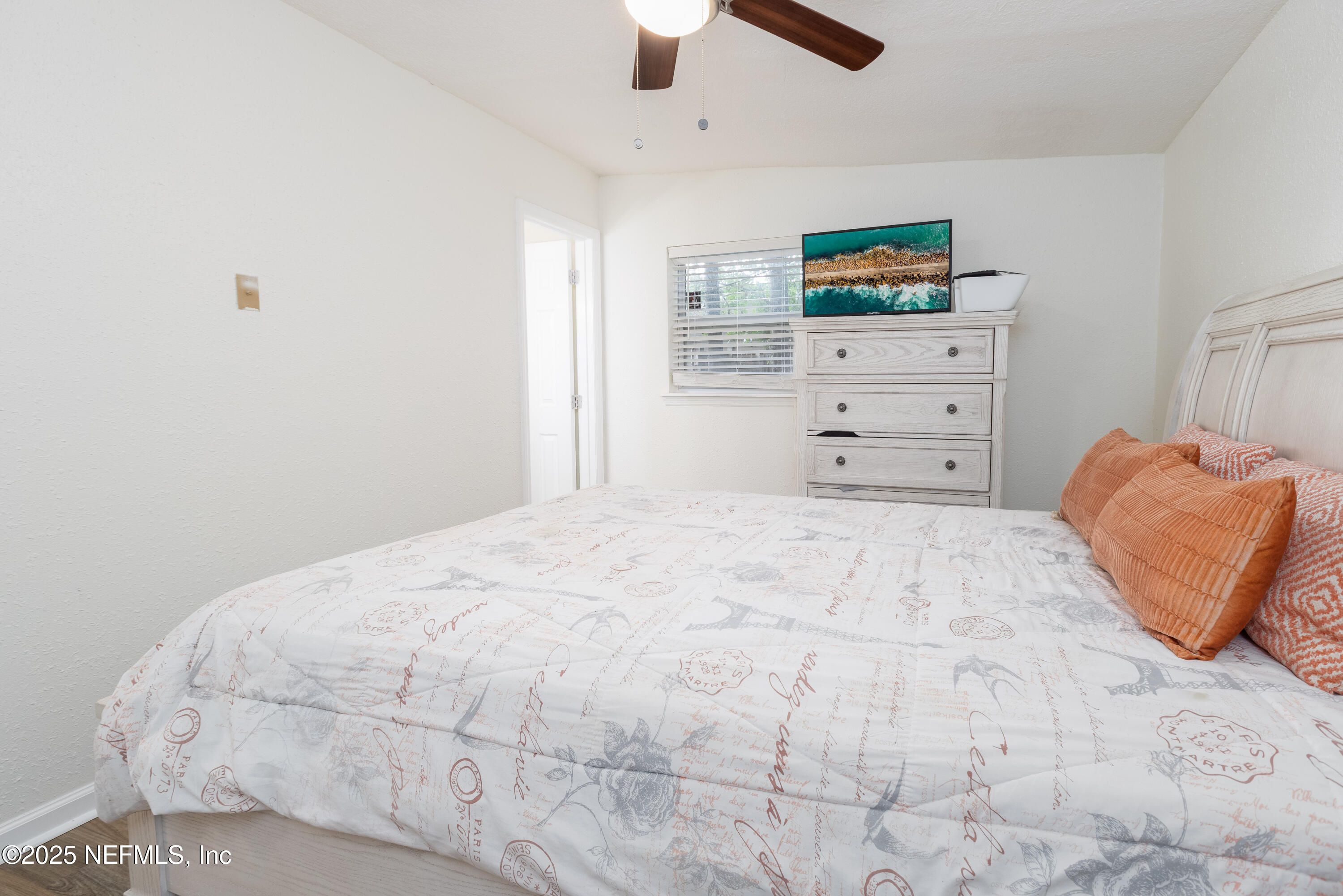 3165 Victoria Park Road Jacksonville, FL 32216 - Photo 11 of 22 a bedroom with a bed and a cabinets