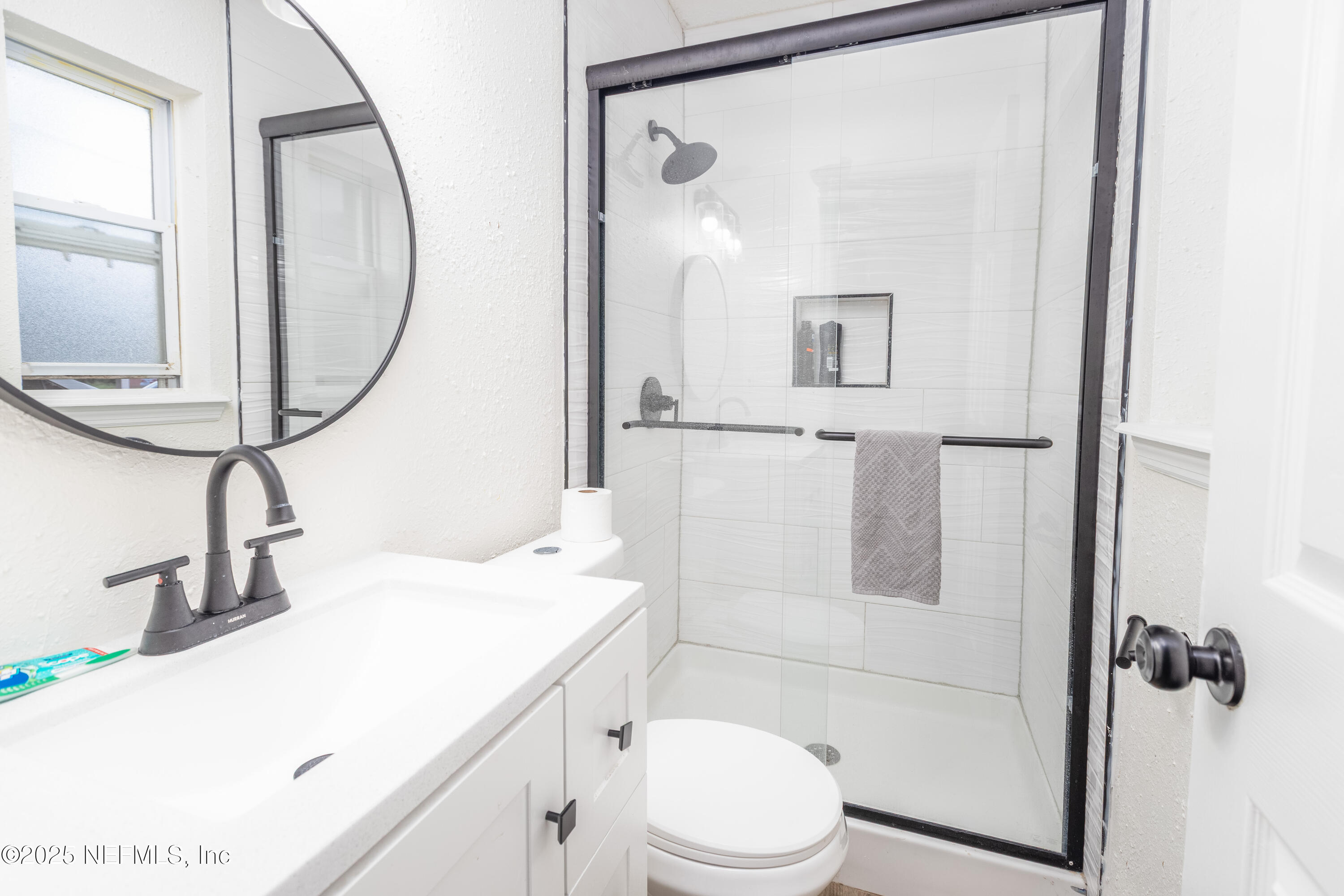 3165 Victoria Park Road Jacksonville, FL 32216 - Photo 12 of 22 a bathroom with a sink a toilet and shower