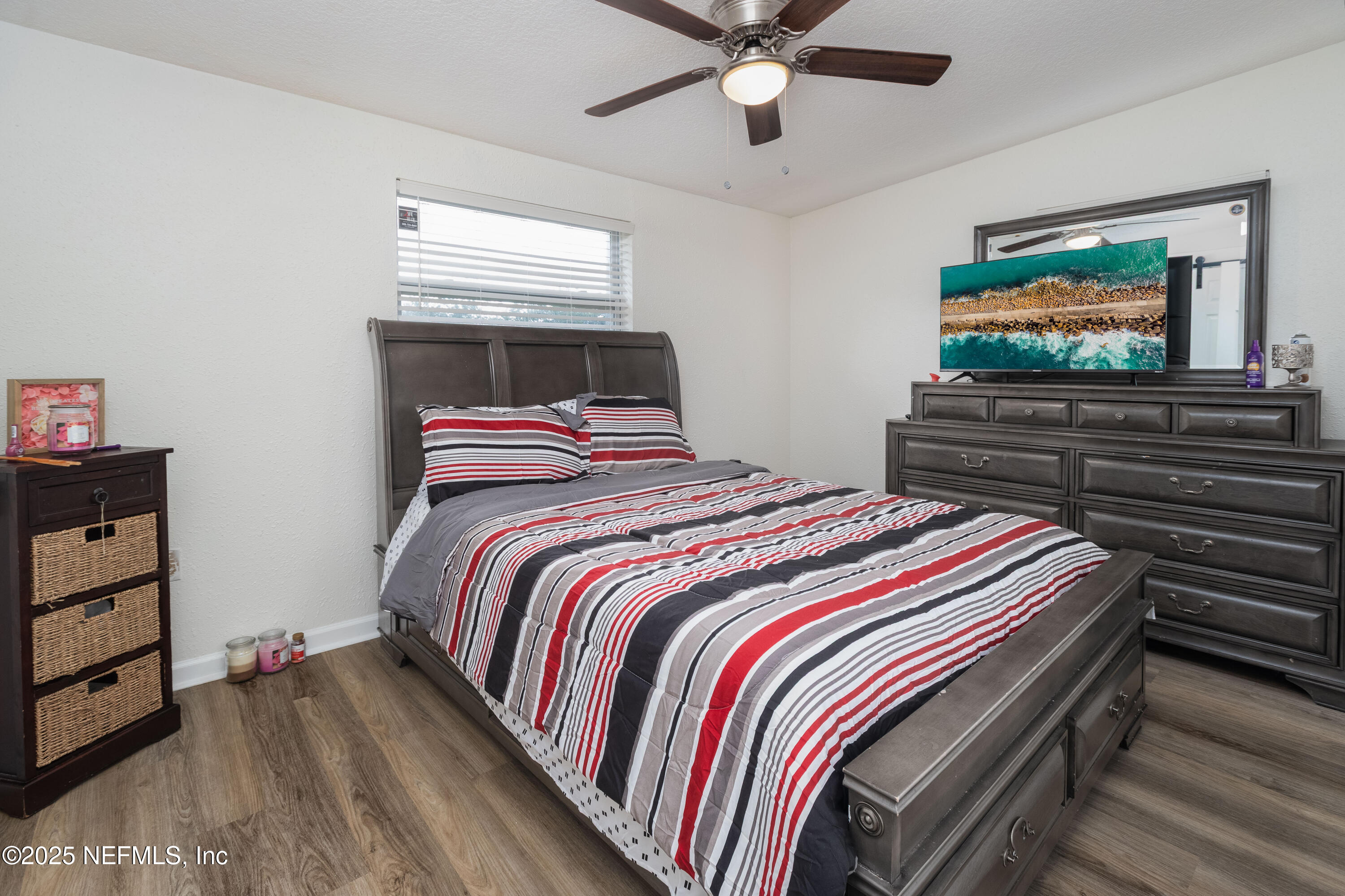3165 Victoria Park Road Jacksonville, FL 32216 - Photo 13 of 22 a bedroom with a bed and a flat screen tv