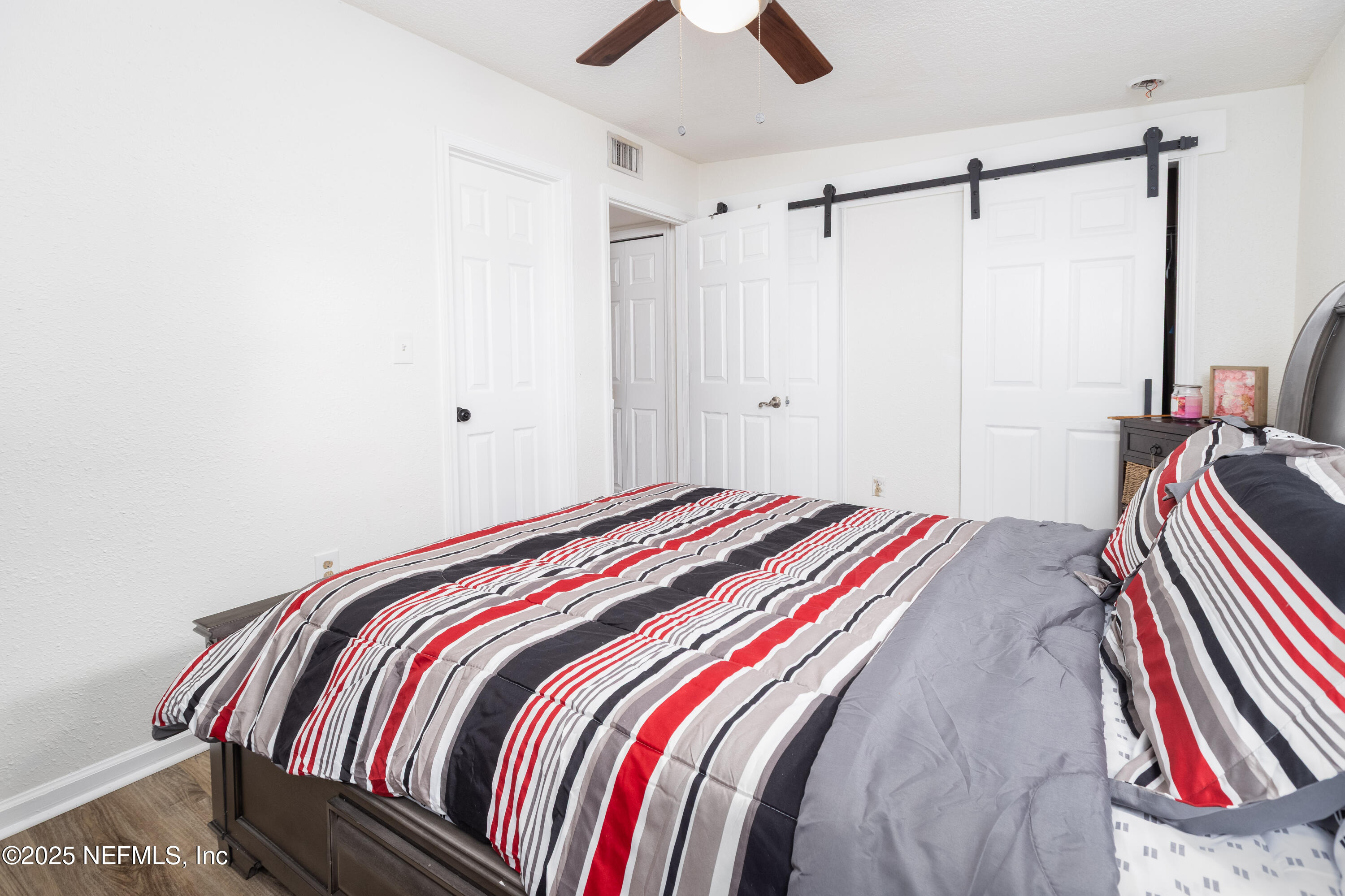 3165 Victoria Park Road Jacksonville, FL 32216 - Photo 14 of 22 a bedroom with a bed and a chandelier