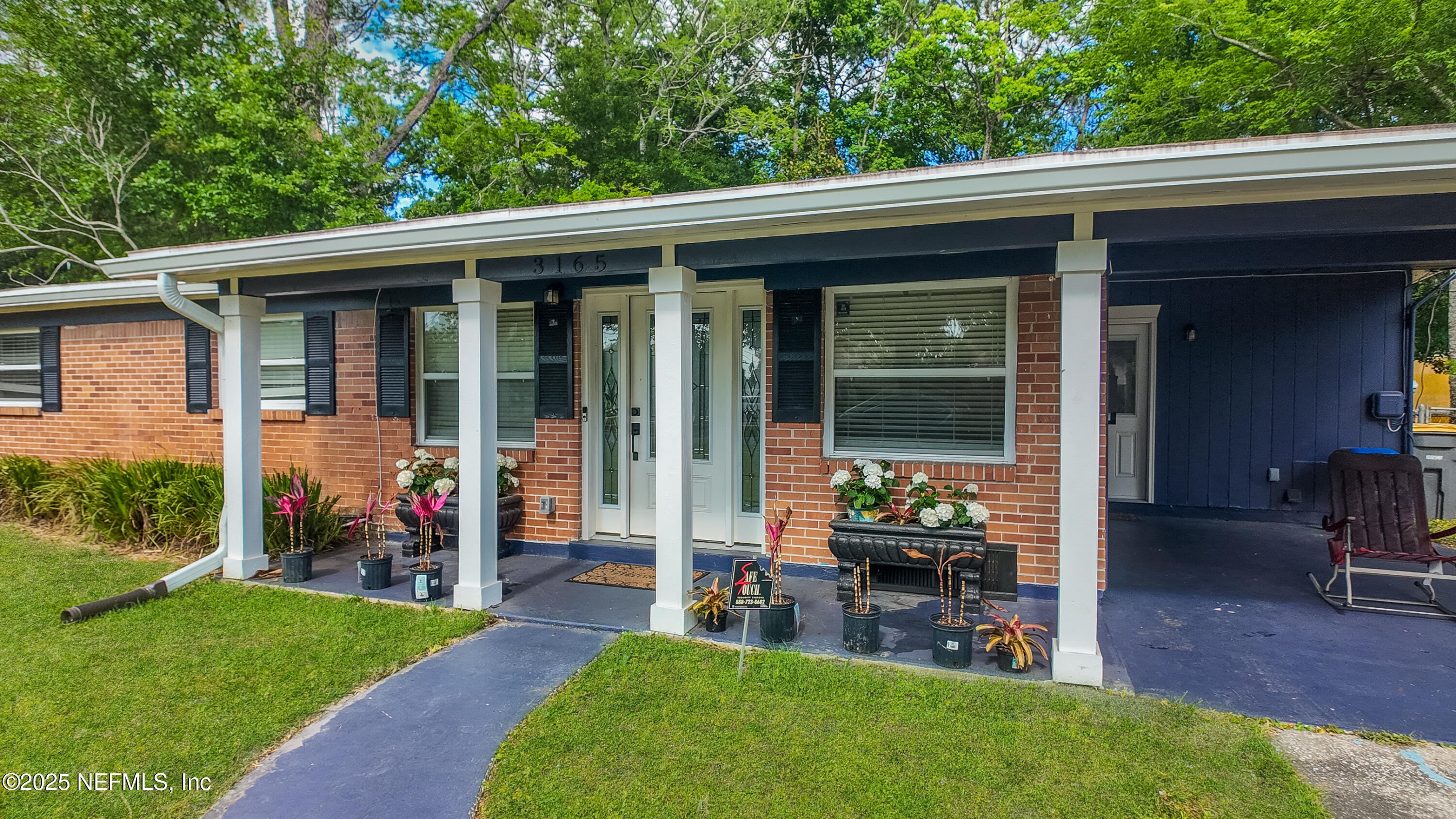 3165 Victoria Park Road Jacksonville, FL 32216 - Photo 19 of 22 a front view of a house with a garden and porch