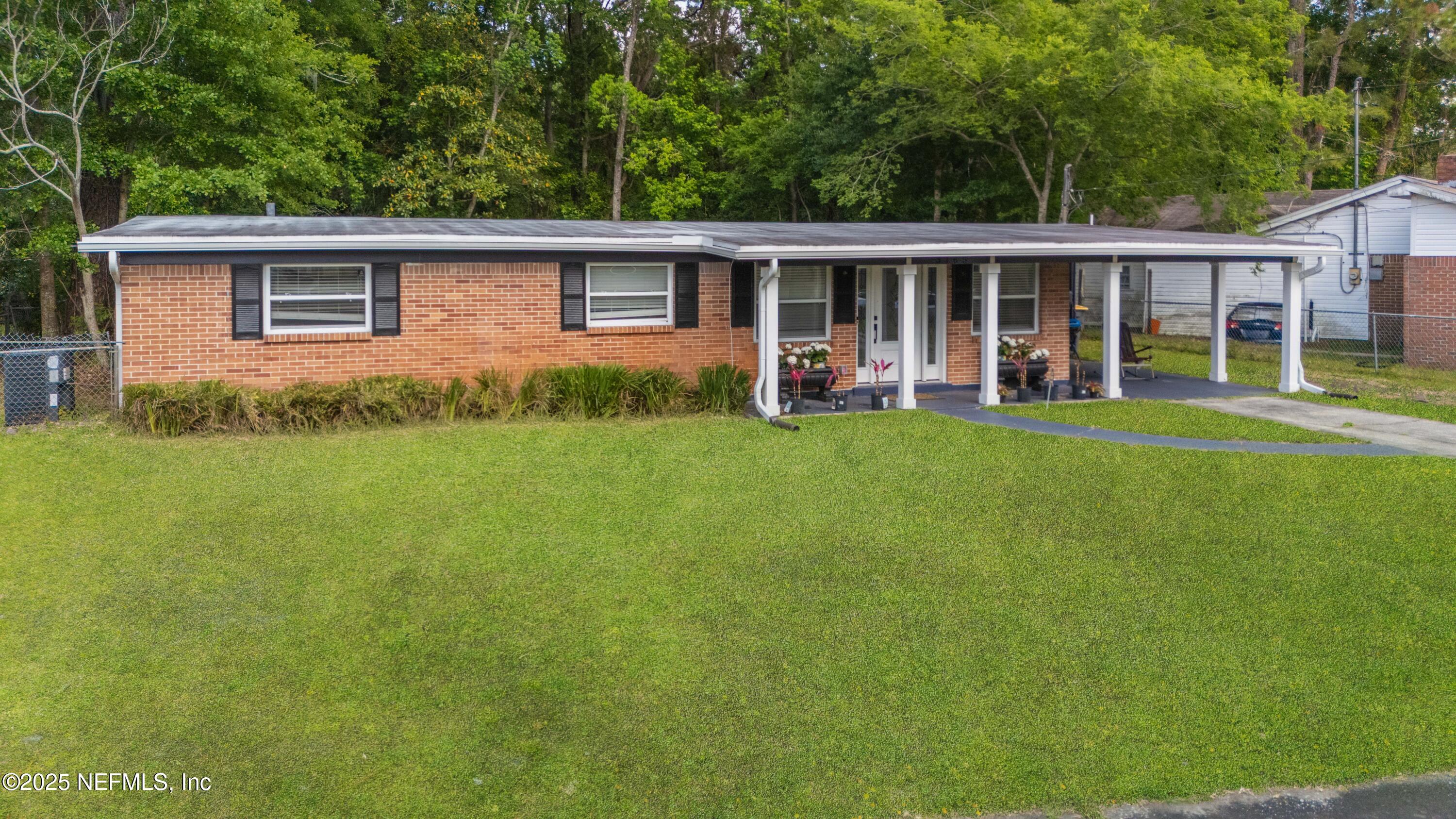 3165 Victoria Park Road Jacksonville, FL 32216 - Photo 20 of 22 a view of a house with backyard sitting area and garden