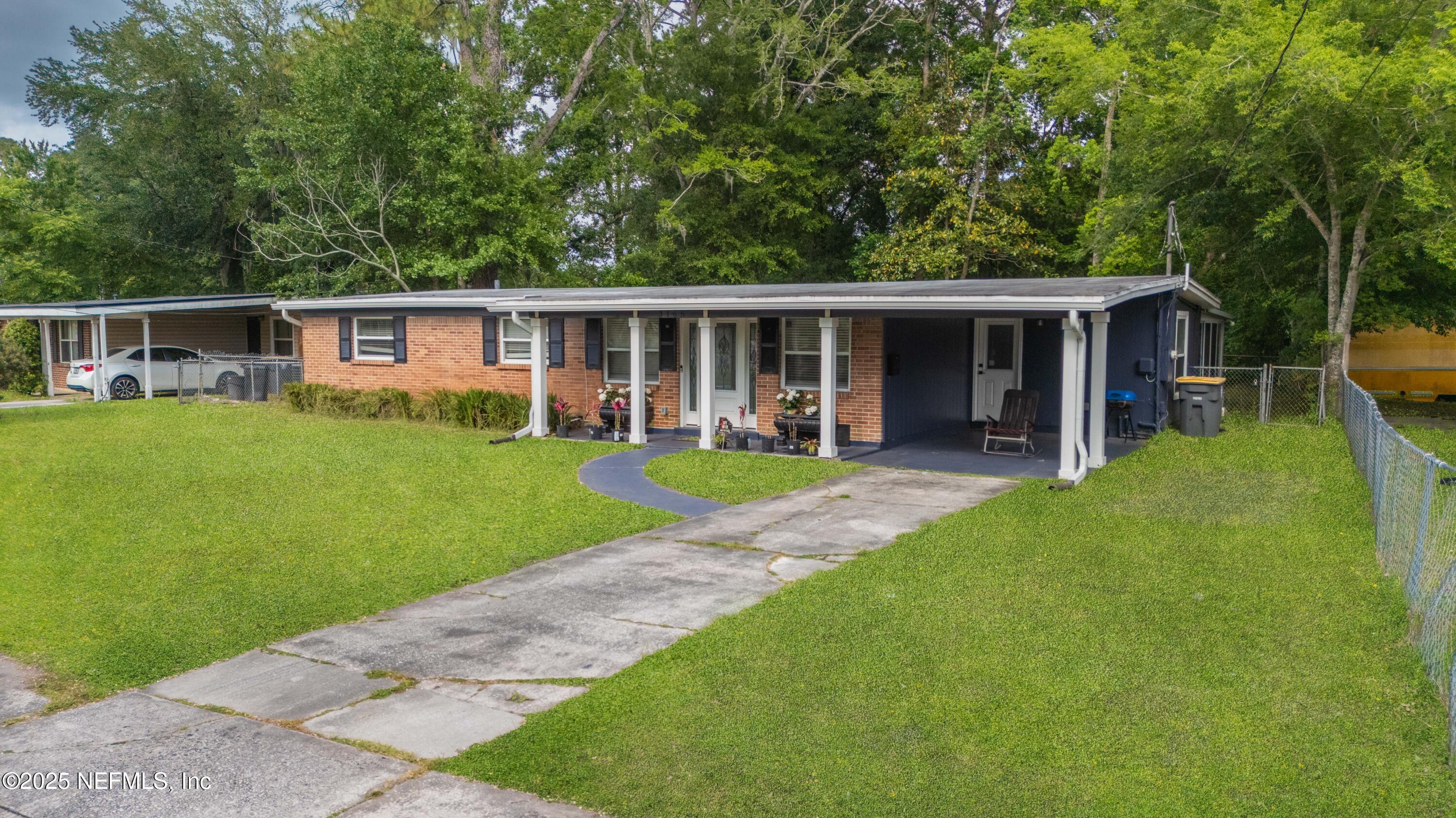 3165 Victoria Park Road Jacksonville, FL 32216 - Photo 22 of 22 a view of a house with a yard and sitting area