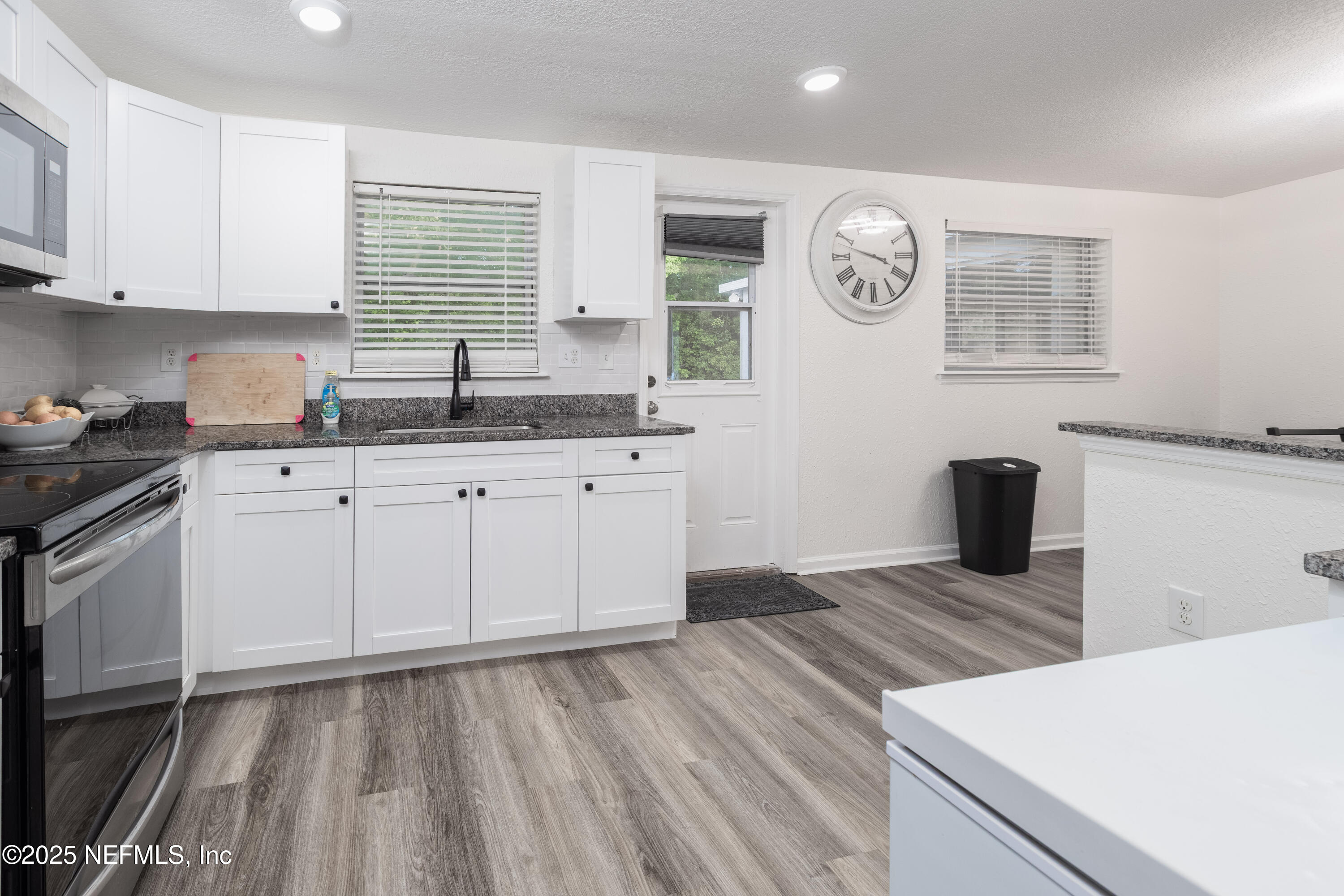 3165 Victoria Park Road Jacksonville, FL 32216 - Photo 6 of 22 a kitchen with granite countertop a sink and a stove top oven