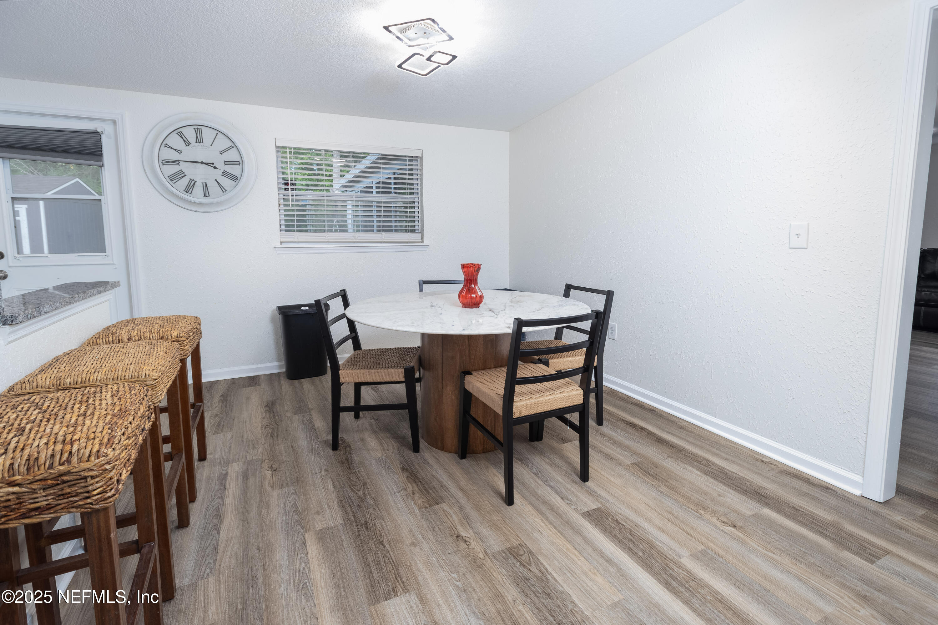 3165 Victoria Park Road Jacksonville, FL 32216 - Photo 8 of 22 a view of a dining room with furniture and wooden floor
