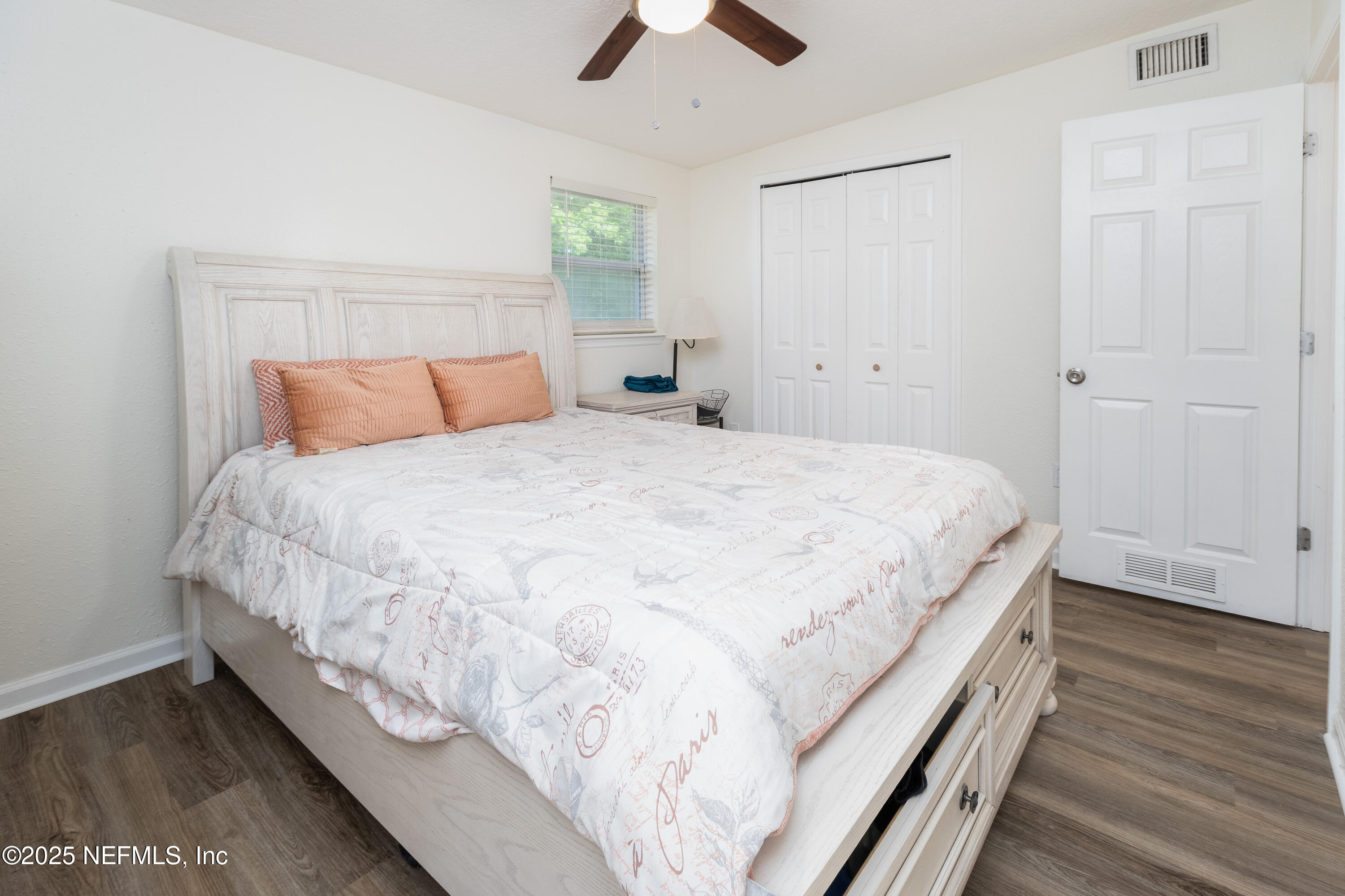 3165 Victoria Park Road Jacksonville, FL 32216 - Photo 10 of 22 a large bed sitting in a bedroom and a chandelier