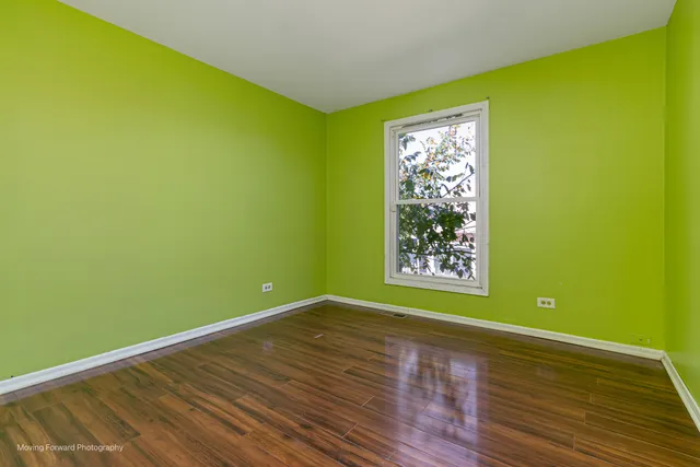 a view of a room with wooden floor and fan