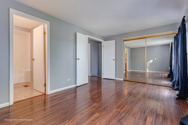 a view of wooden floor and windows in an empty room