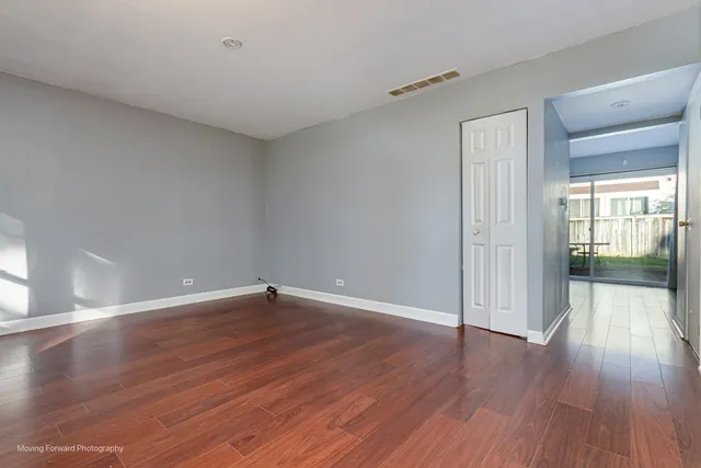 a view of an empty room and wooden floor