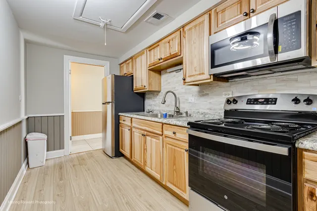 a kitchen with stainless steel appliances granite countertop a stove and a sink
