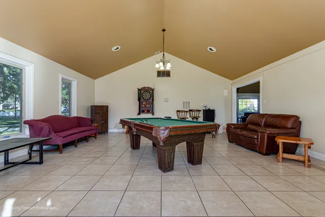 a living room with furniture a table and a large window
