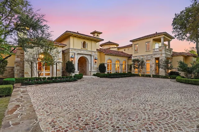 a view of a white house with a street