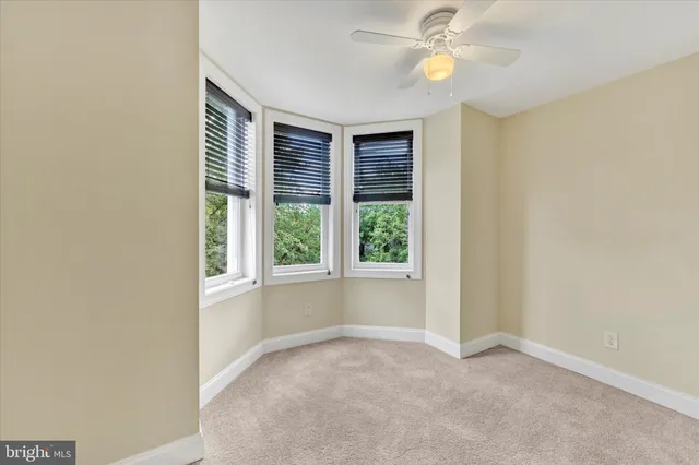 an empty room with windows and closet