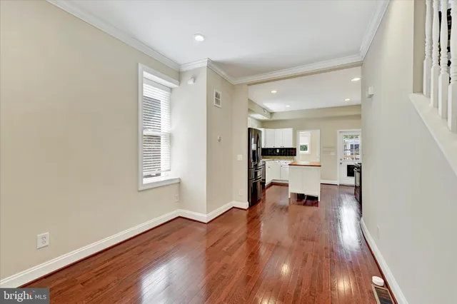 a view of kitchen with livingroom and wooden floor