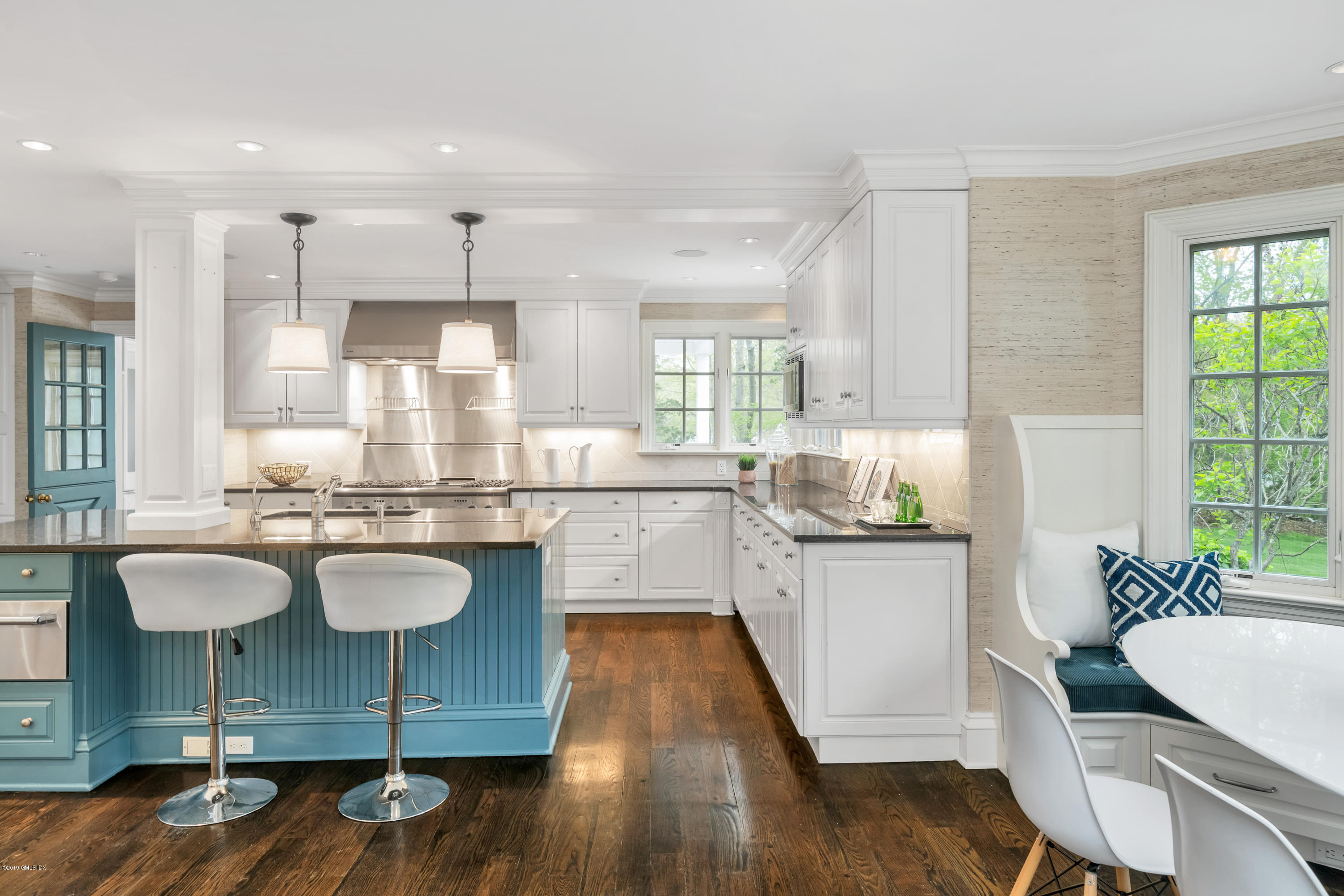 8 Juniper Hill Road Greenwich, CT 06830 - Photo 12 of 27 a kitchen with kitchen island granite countertop wooden floors and stainless steel appliances