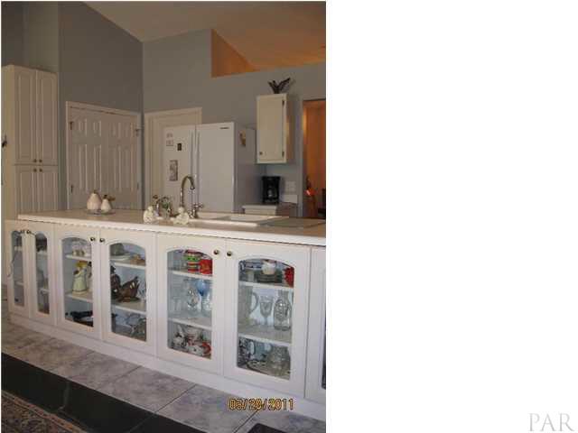 6911 Cedar Ridge Circle Milton, FL 32570 - Photo 7 of 11 Glass front display cabinets at kitchen bar.
