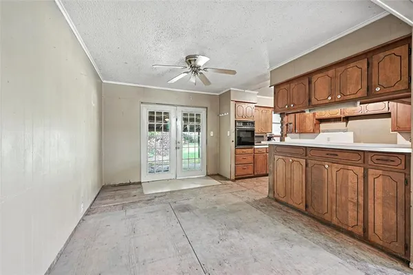 a kitchen with granite countertop a refrigerator and cabinets