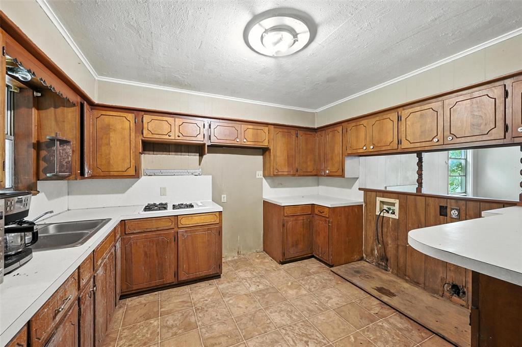 414 South Broadway Street Bells, TX 75414 - Photo 12 of 29 a kitchen with stainless steel appliances granite countertop a sink stove and cabinets