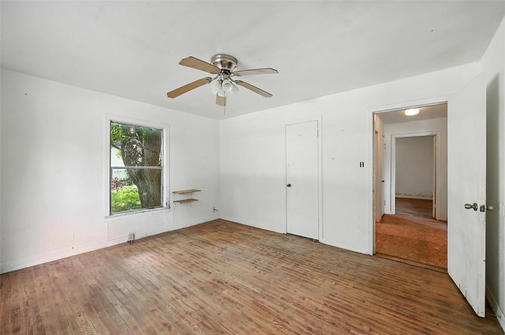 414 South Broadway Street Bells, TX 75414 - Photo 16 of 29 wooden floor in an empty room with a window