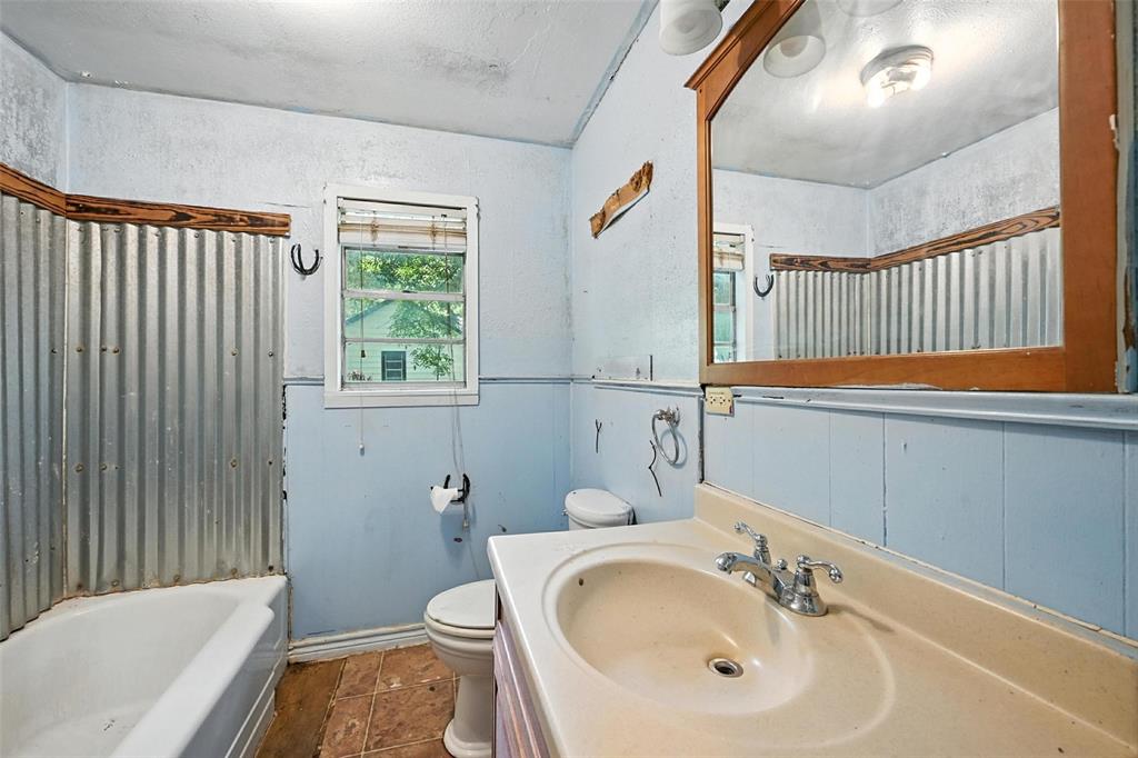 414 South Broadway Street Bells, TX 75414 - Photo 18 of 29 a bathroom with a sink and a bathtub