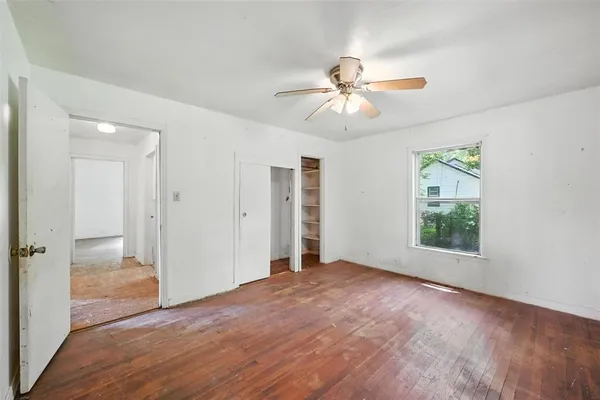 wooden floor in an empty room with a window