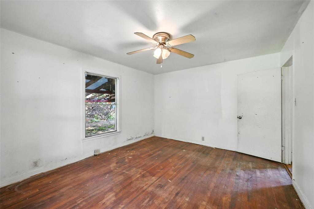 414 South Broadway Street Bells, TX 75414 - Photo 21 of 29 wooden floor in an empty room with a window