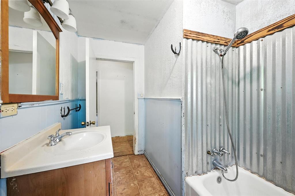 414 South Broadway Street Bells, TX 75414 - Photo 23 of 29 a bathroom with a sink and mirror