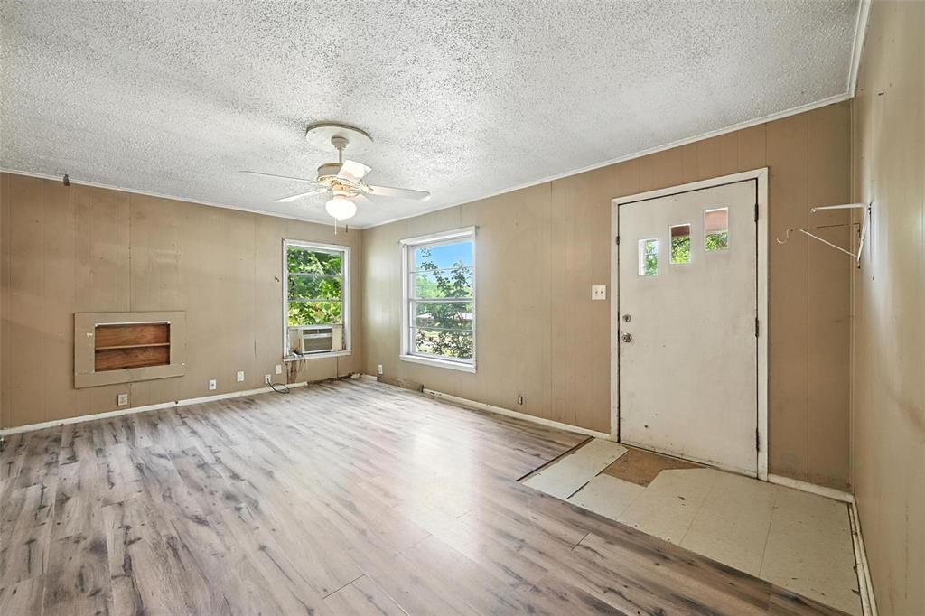 414 South Broadway Street Bells, TX 75414 - Photo 7 of 29 wooden floor in an empty room with a window