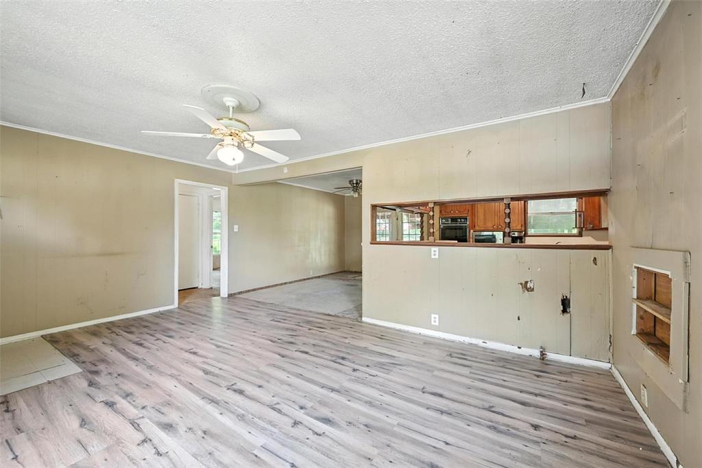 414 South Broadway Street Bells, TX 75414 - Photo 9 of 29 a view of a room with wooden floor and ceiling fan