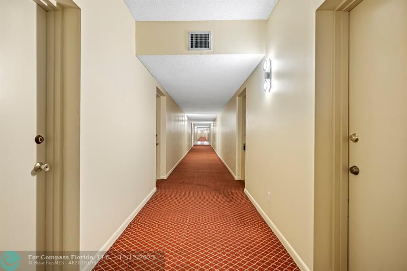 4750 Northwest 22nd Court, Unit 417 Lauderhill, FL 33313 - Photo 5 of 24 a view of a hallway with wooden floor and closet
