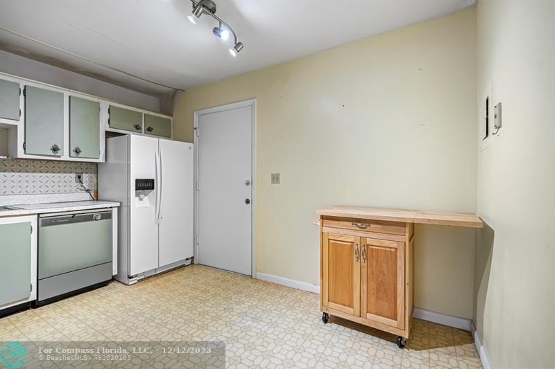 4750 Northwest 22nd Court, Unit 417 Lauderhill, FL 33313 - Photo 9 of 24 a view of a kitchen with a sink and a refrigerator