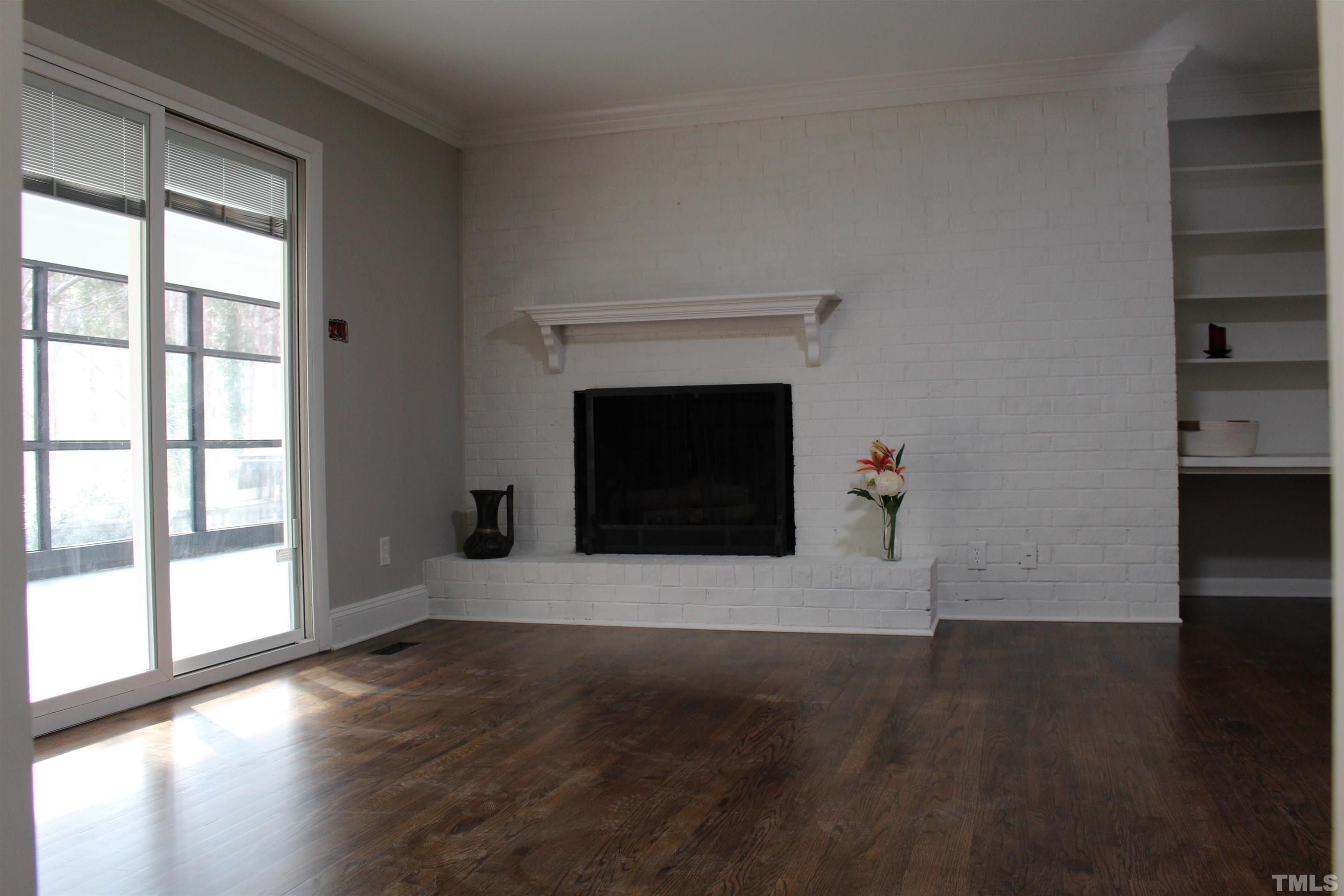 5335 Russell Road Durham, NC 27712 - Photo 7 of 31 a view of an empty room with wooden floor and a window