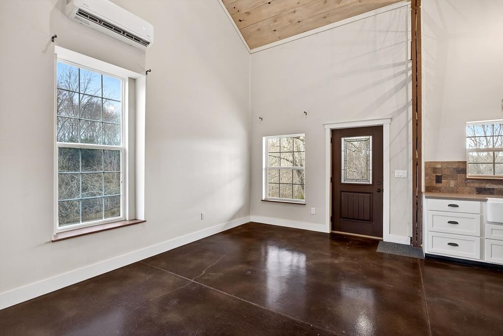 1425 Moodyville Loop Byrdstown, TN 38549 - Photo 12 of 62 a view of an empty room with a window and wooden floor