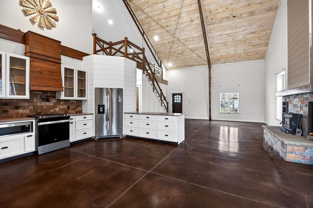 1425 Moodyville Loop Byrdstown, TN 38549 - Photo 14 of 62 a kitchen with stainless steel appliances a stove a sink and a refrigerator