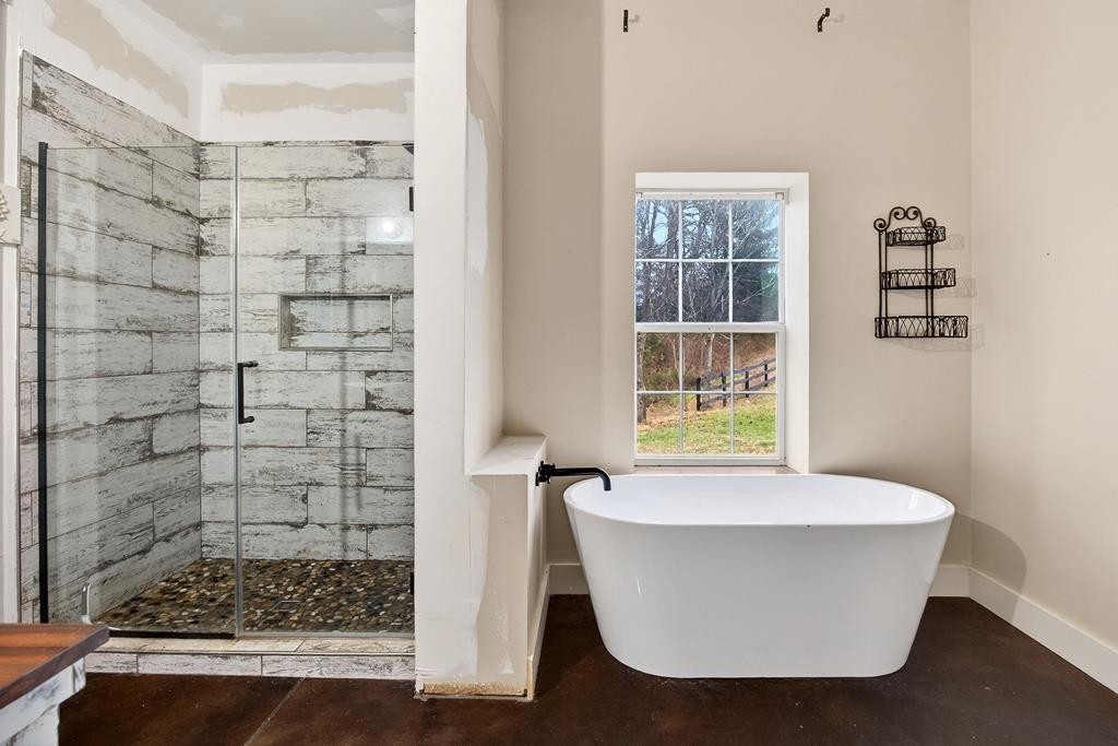 1425 Moodyville Loop Byrdstown, TN 38549 - Photo 22 of 62 a white bath tub sitting in a bathroom