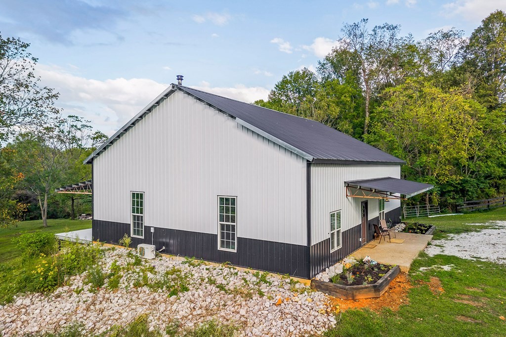 1425 Moodyville Loop Byrdstown, TN 38549 - Photo 4 of 62 a view of a white house next to a yard with big trees