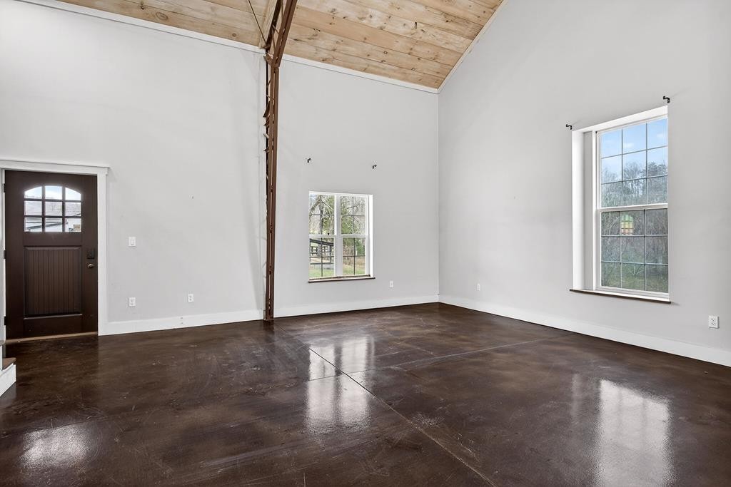 1425 Moodyville Loop Byrdstown, TN 38549 - Photo 9 of 62 an empty room with wooden floor and windows
