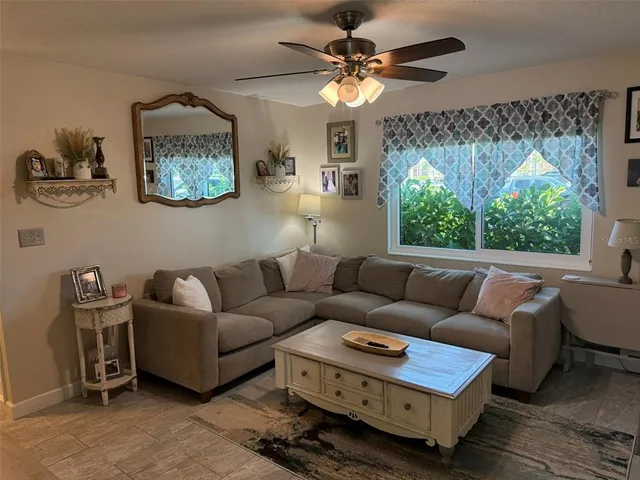 a living room with furniture and a large window