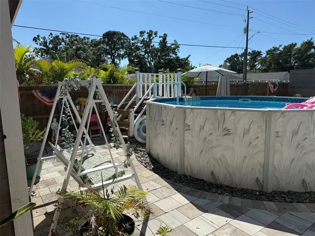 a view of a patio with couches and potted plants