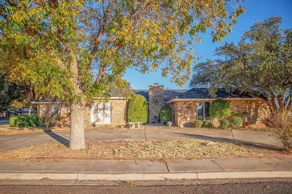 a front view of a building with trees