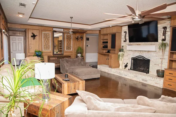 a living room with furniture a fireplace and a flat screen tv