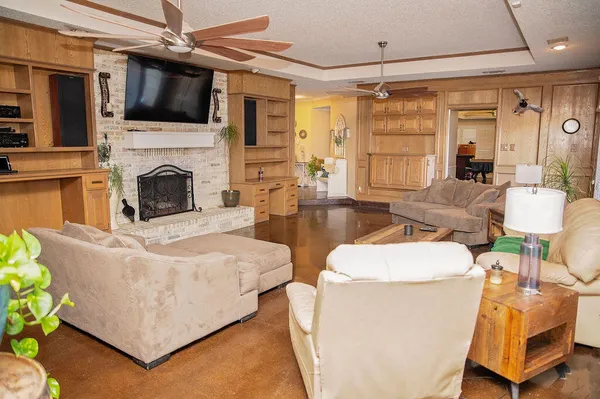 a living room with furniture a flat screen tv and a fireplace