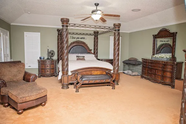 a bedroom with furniture and a chandelier