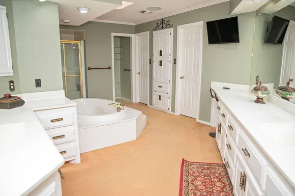 a bathroom with a tub sink and mirror