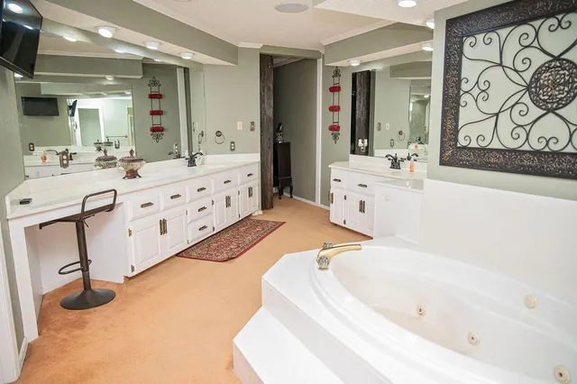 a large white tub sitting in a bathroom