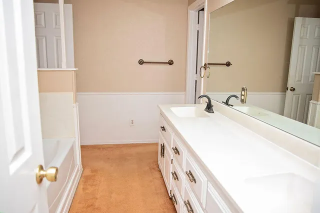 a spacious bathroom with a sink and a mirror