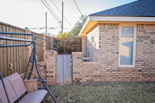 a backyard of a house with table and chairs