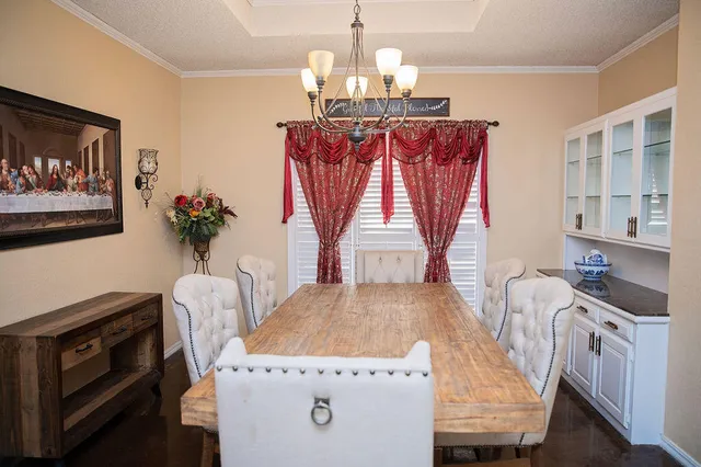 a view of a dining room with furniture and chandelier