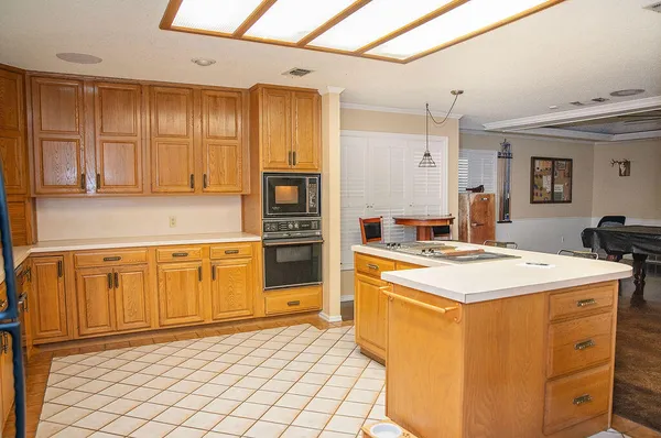 a kitchen with stainless steel appliances granite countertop a stove a sink and a refrigerator
