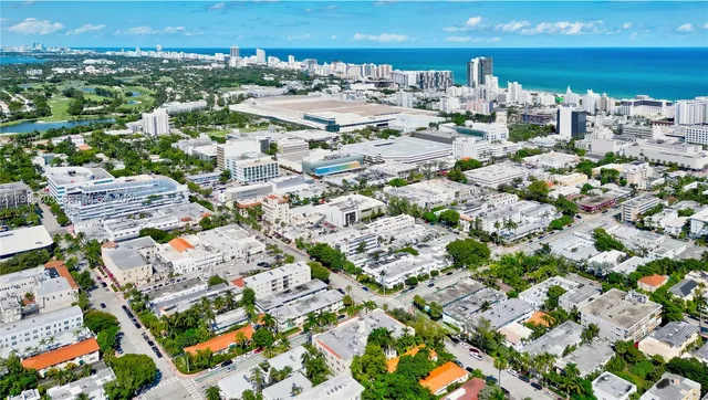 a view of wooden floor and a chandelier fan in a room